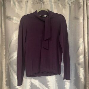 Merino wool classic long sleeve sweater with tie at neck. New from Simons